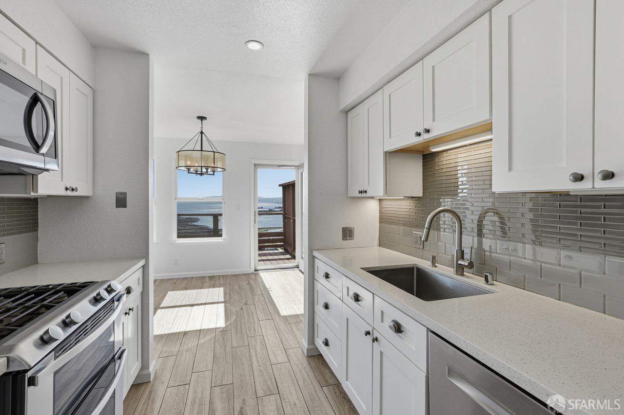 59 Kiska Road San Francisco, CA 94124 - Photo 10 of 46 a kitchen with stainless steel appliances granite countertop a sink stove and cabinets