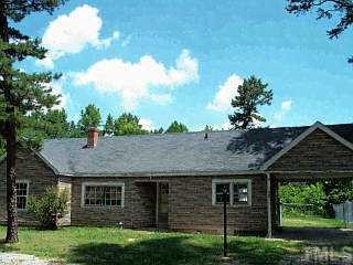270 Semora Road Roxboro, NC 27573 - Photo 1 of 1 a view of a brick house next to a yard