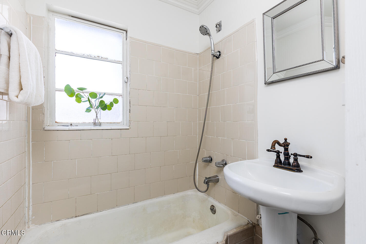 114 South Canyon Boulevard Monrovia, CA 91016 - Photo 13 of 32 a bathroom with a sink a window and a bathtub