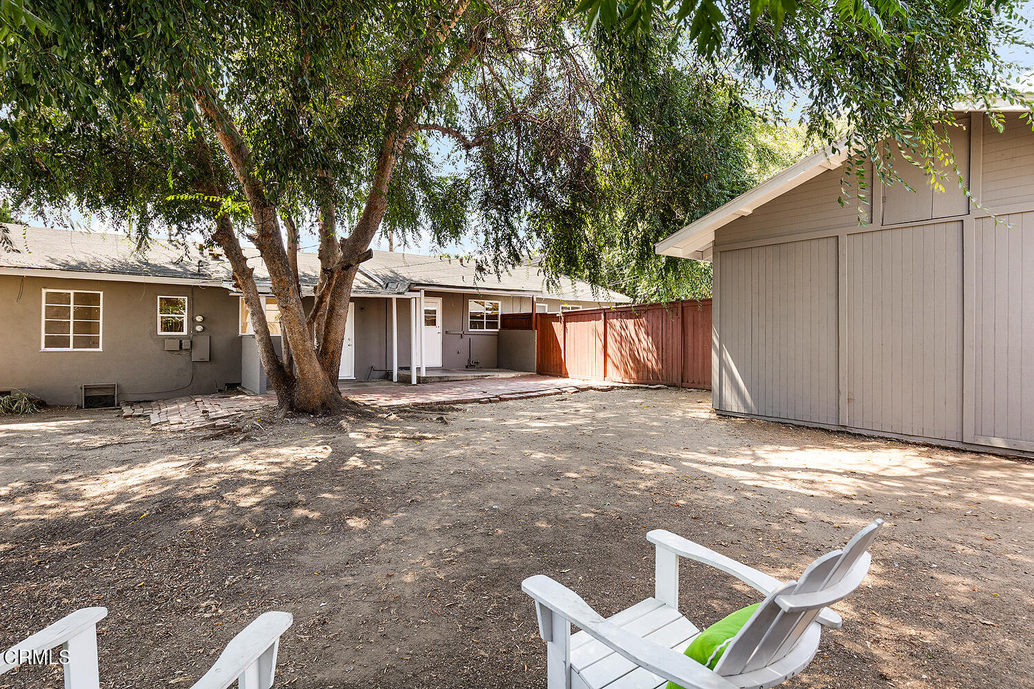 114 South Canyon Boulevard Monrovia, CA 91016 - Photo 27 of 32 a backyard of a house with wooden fence and large trees