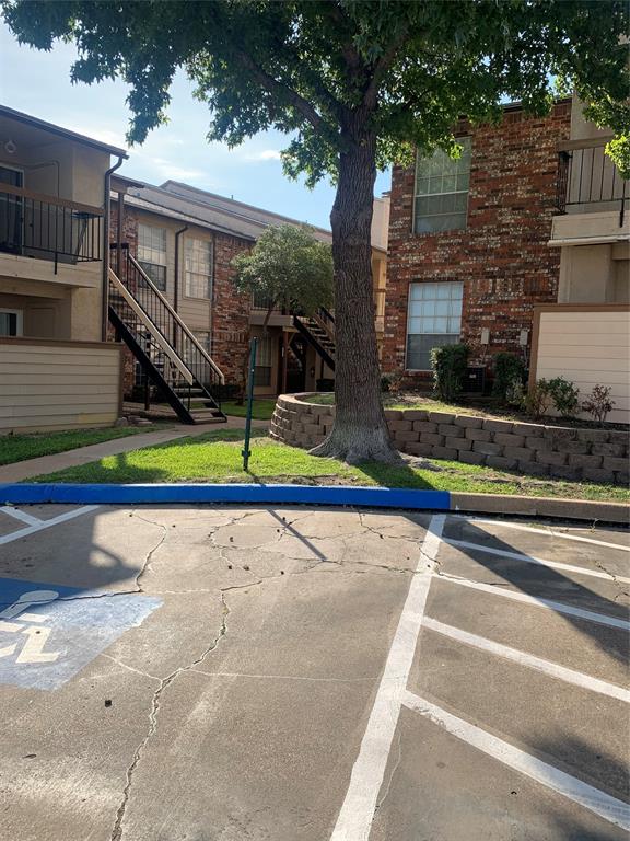 12482 Abrams Road, Unit 1303 Dallas, TX 75243 - Photo 30 of 30 Exterior facade featuring brick and siding, multiple balconies with metal railings, and a prominent mature tree