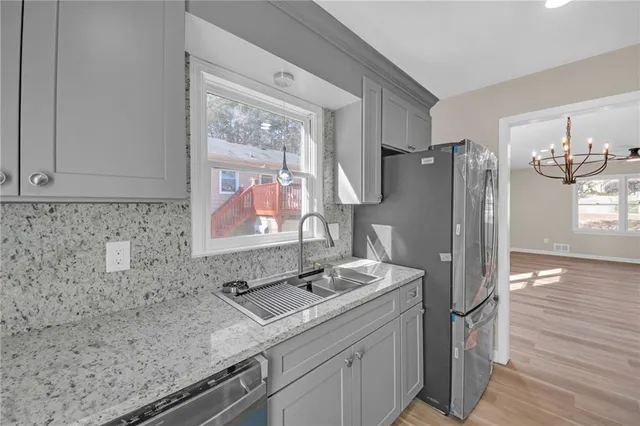 a bathroom with a sink a mirror and a shower
