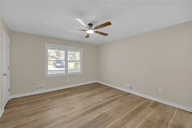 wooden floor in an empty room with a window