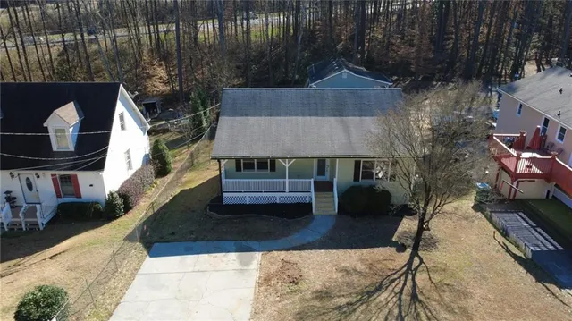 an aerial view of a house with a yard