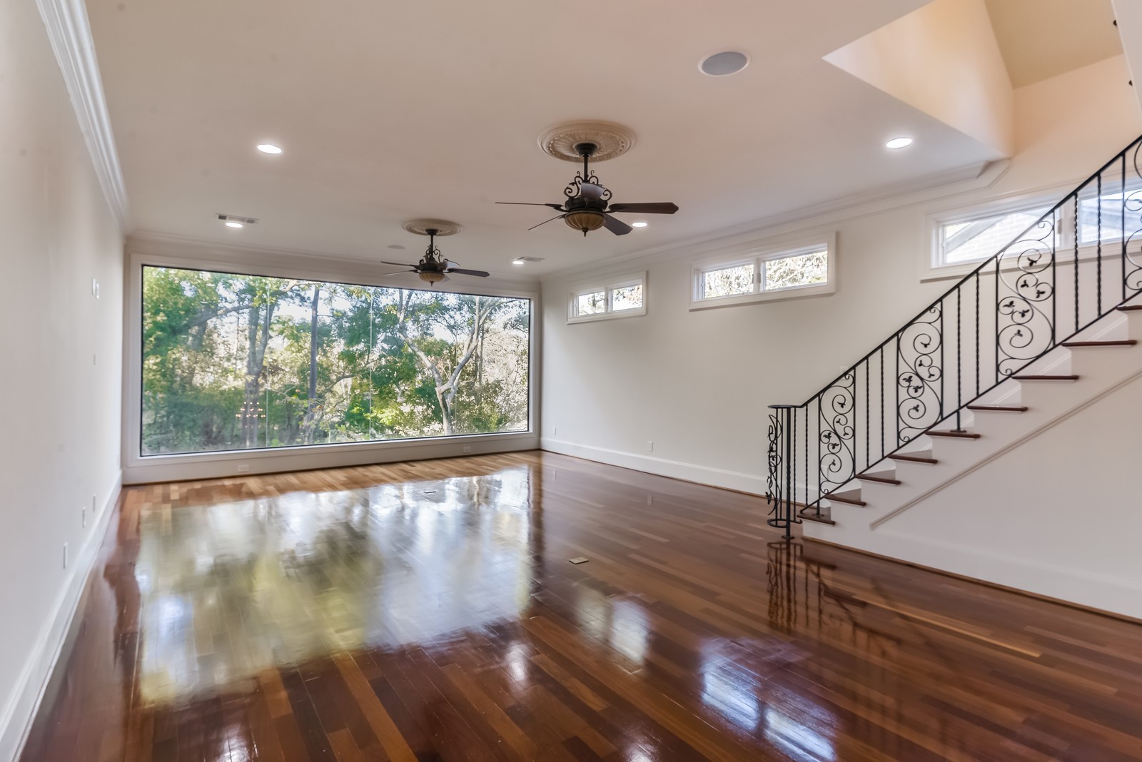 15 West Shady Lane, Unit B Houston, TX 77063 - Photo 11 of 19 a view of empty room with wooden floor and fan
