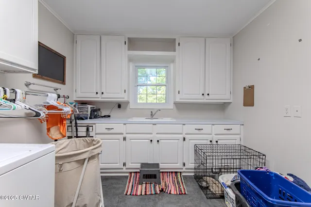 a kitchen with a sink stove and white cabinets