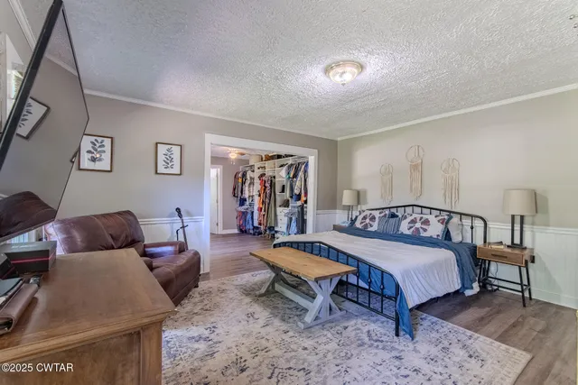 a bedroom with a bed and a table in it