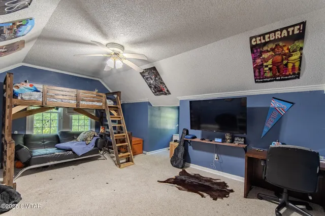 a room with gym equipment and a flat screen tv