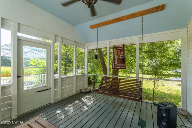 a view of a balcony with floor to ceiling windows with wooden floor