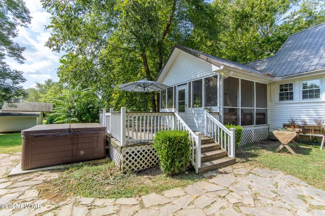 a view of a chair and table in the backyard