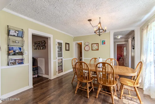 a view of a dining room with furniture wooden floor and a chandelier