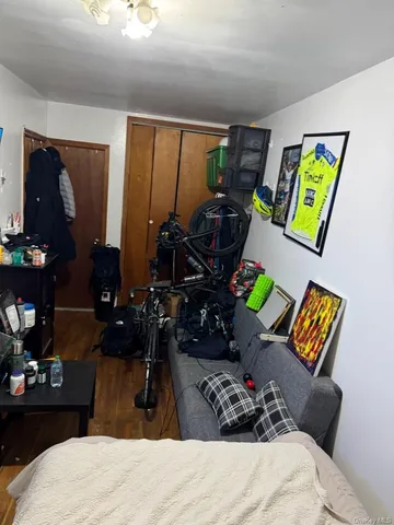 a bedroom with bed and wooden floor