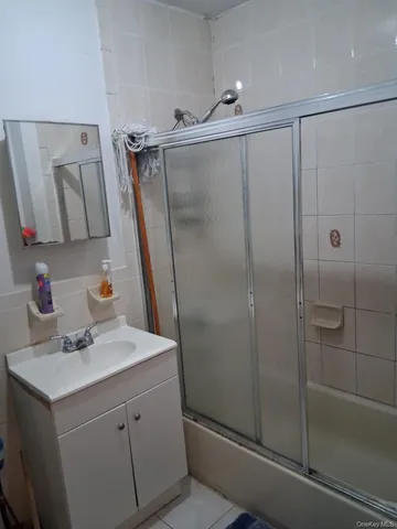 a bathroom with a sink mirror and shower