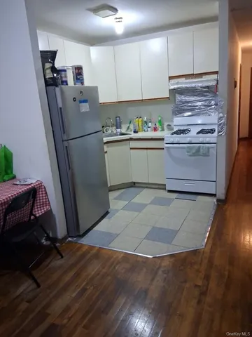 a kitchen with a refrigerator sink and cabinets