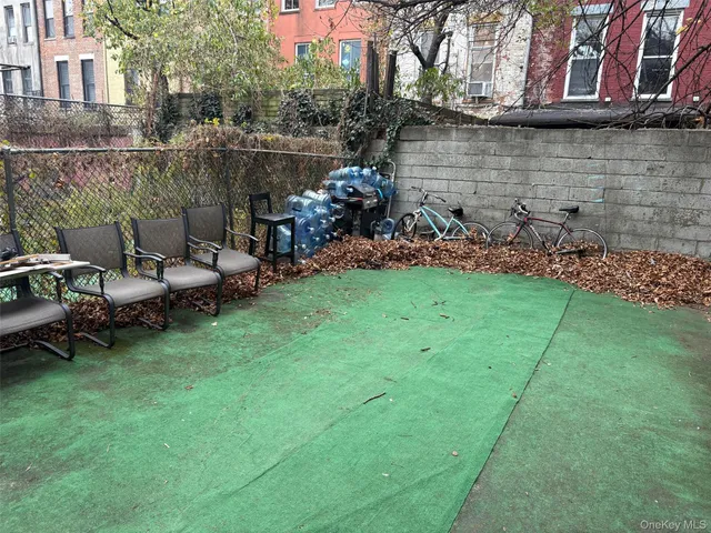 a backyard of a house with table and chairs