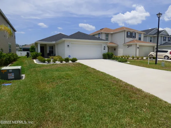 a front view of a house with garden and porch