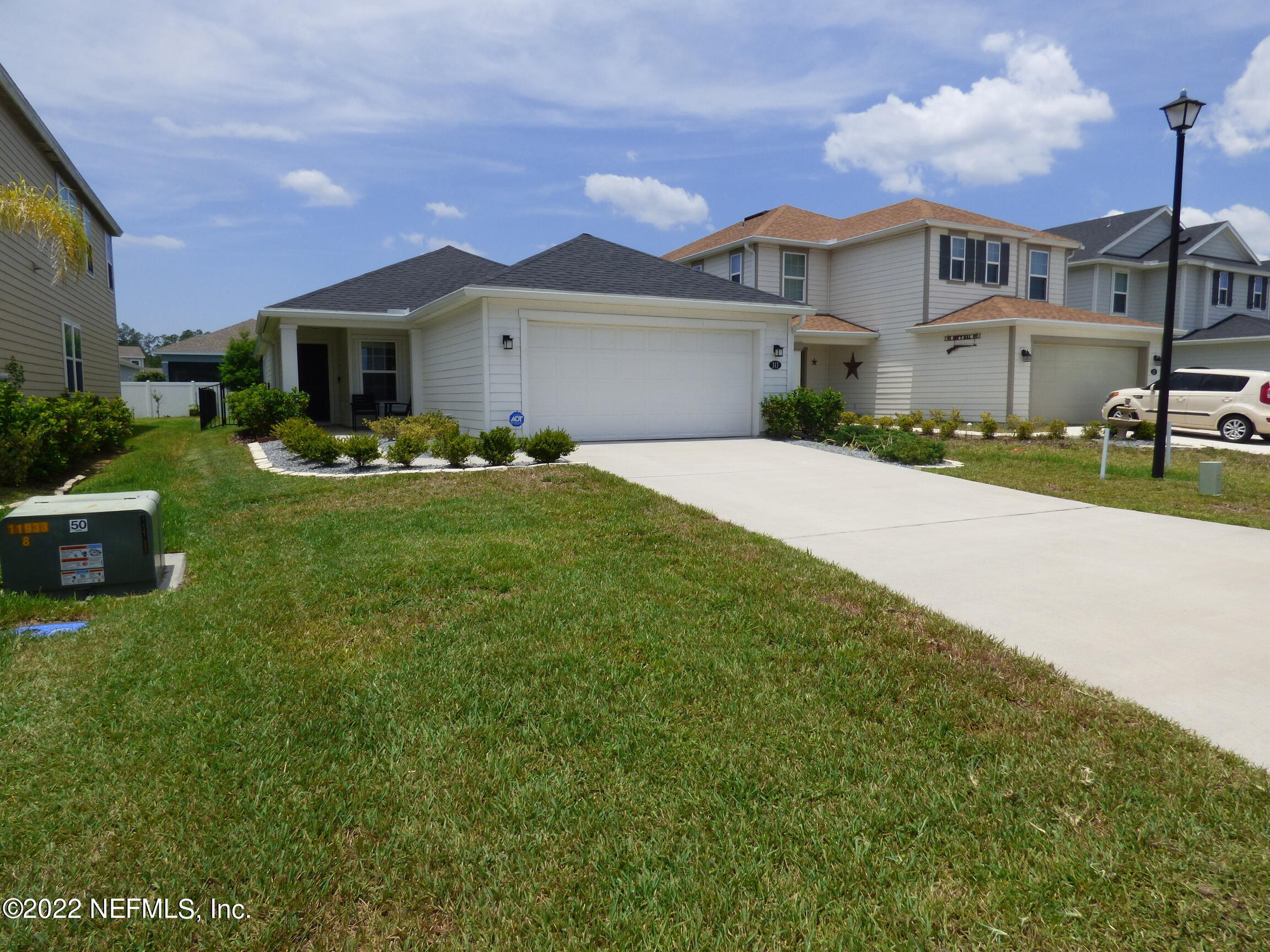 a front view of a house with garden and porch