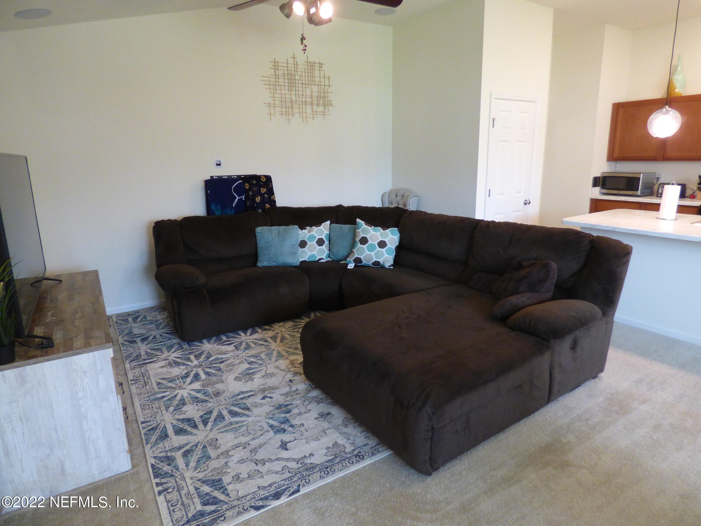 313 Bluejack Lane St. Augustine, FL 32095 - Photo 11 of 46 a living room with furniture and a flat screen tv
