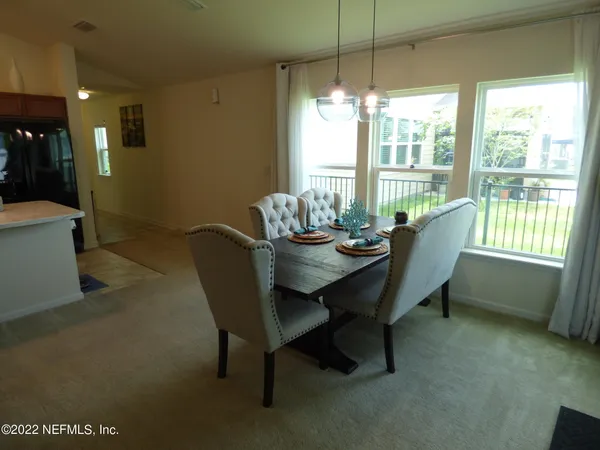 a view of a dining room with furniture window and outside view