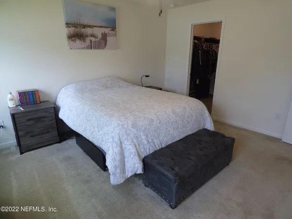 a bed sitting in a bedroom next to a window