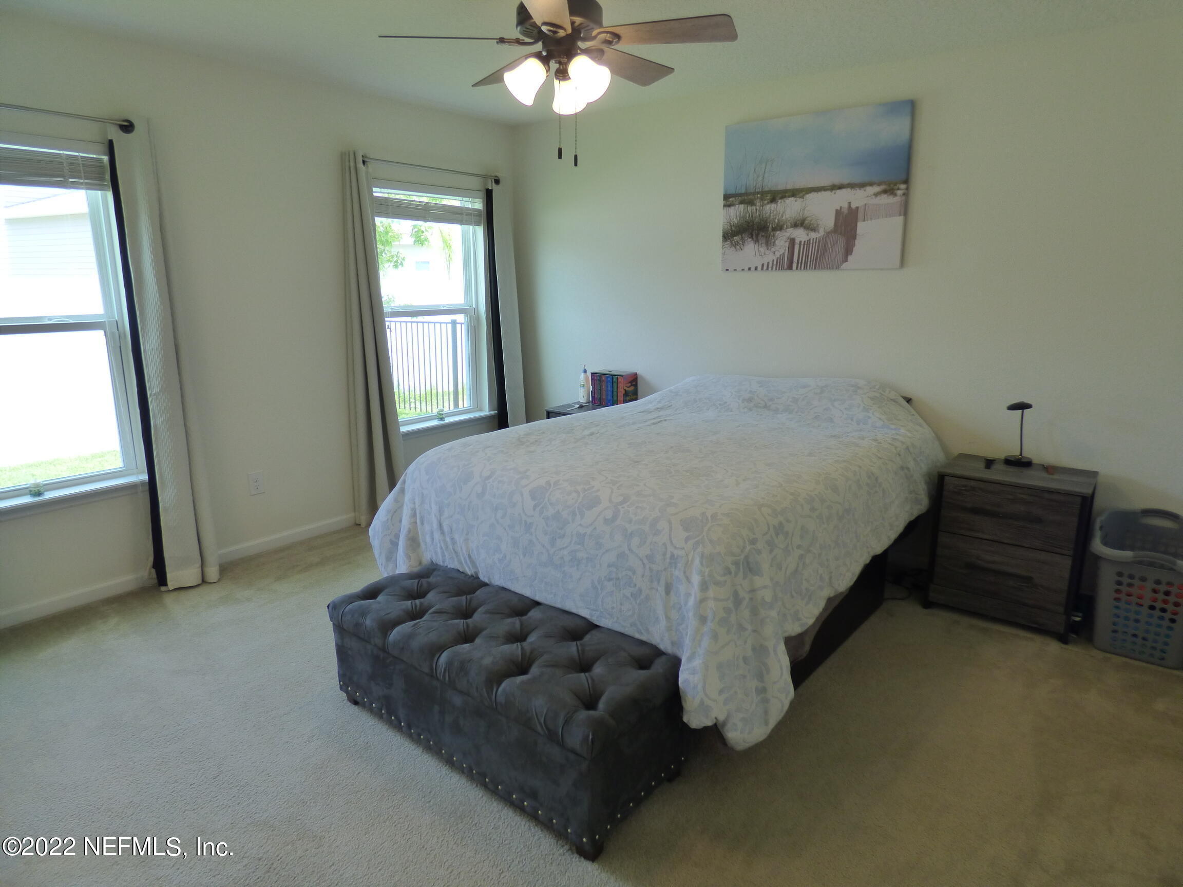 313 Bluejack Lane St. Augustine, FL 32095 - Photo 17 of 46 a bed sitting in a bedroom next to a window