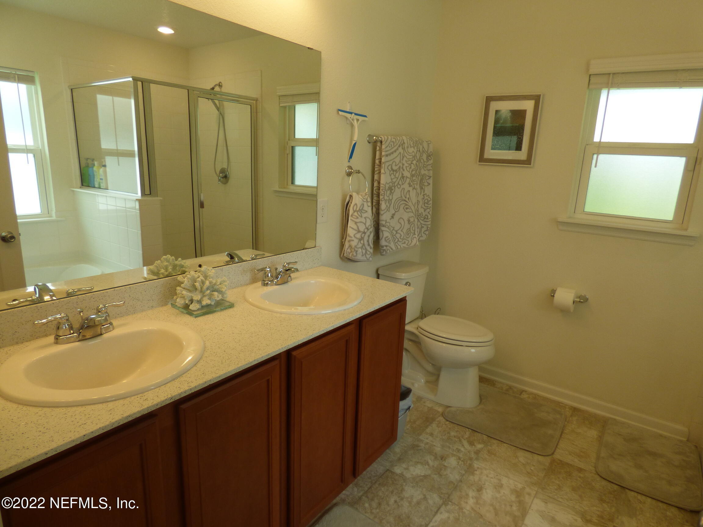 313 Bluejack Lane St. Augustine, FL 32095 - Photo 18 of 46 a bathroom with a granite countertop sink toilet and shower