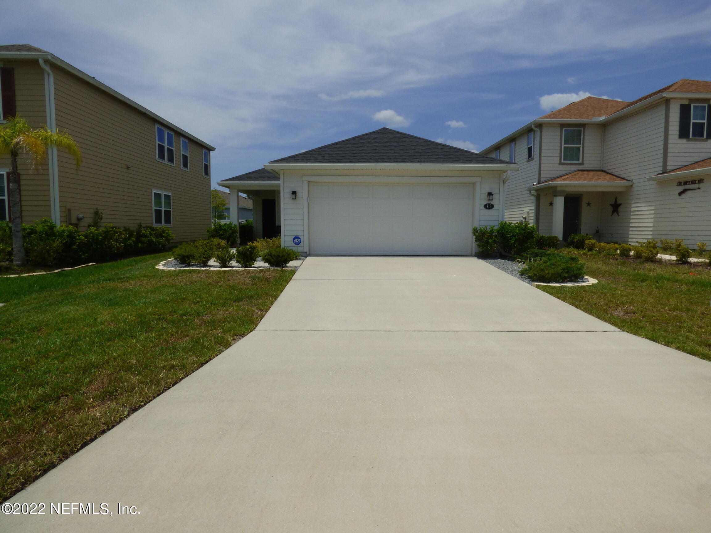 313 Bluejack Lane St. Augustine, FL 32095 - Photo 2 of 46 a front view of a house with a yard and garage