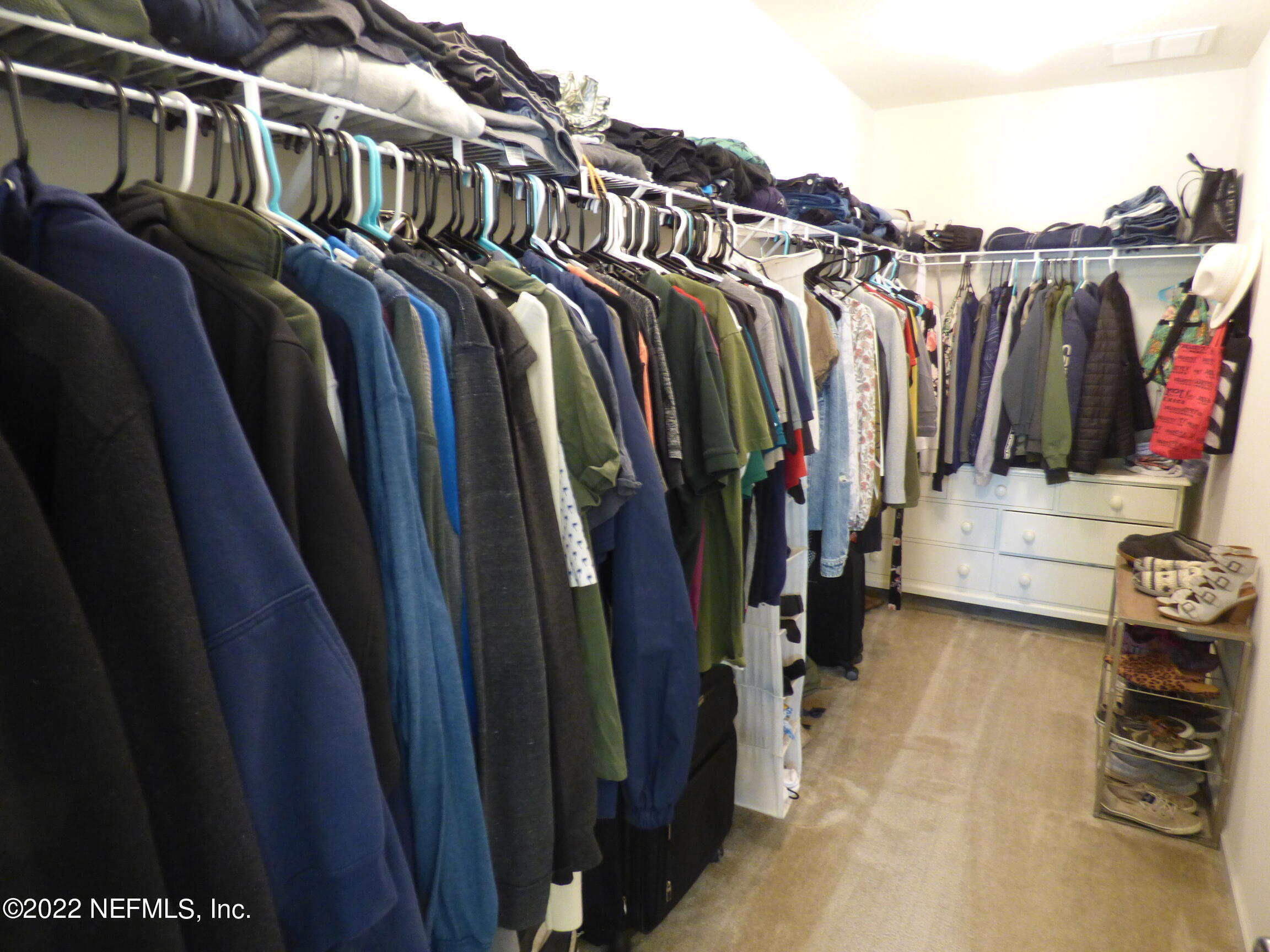 313 Bluejack Lane St. Augustine, FL 32095 - Photo 21 of 46 a view of walk in closet with clothes and shoes