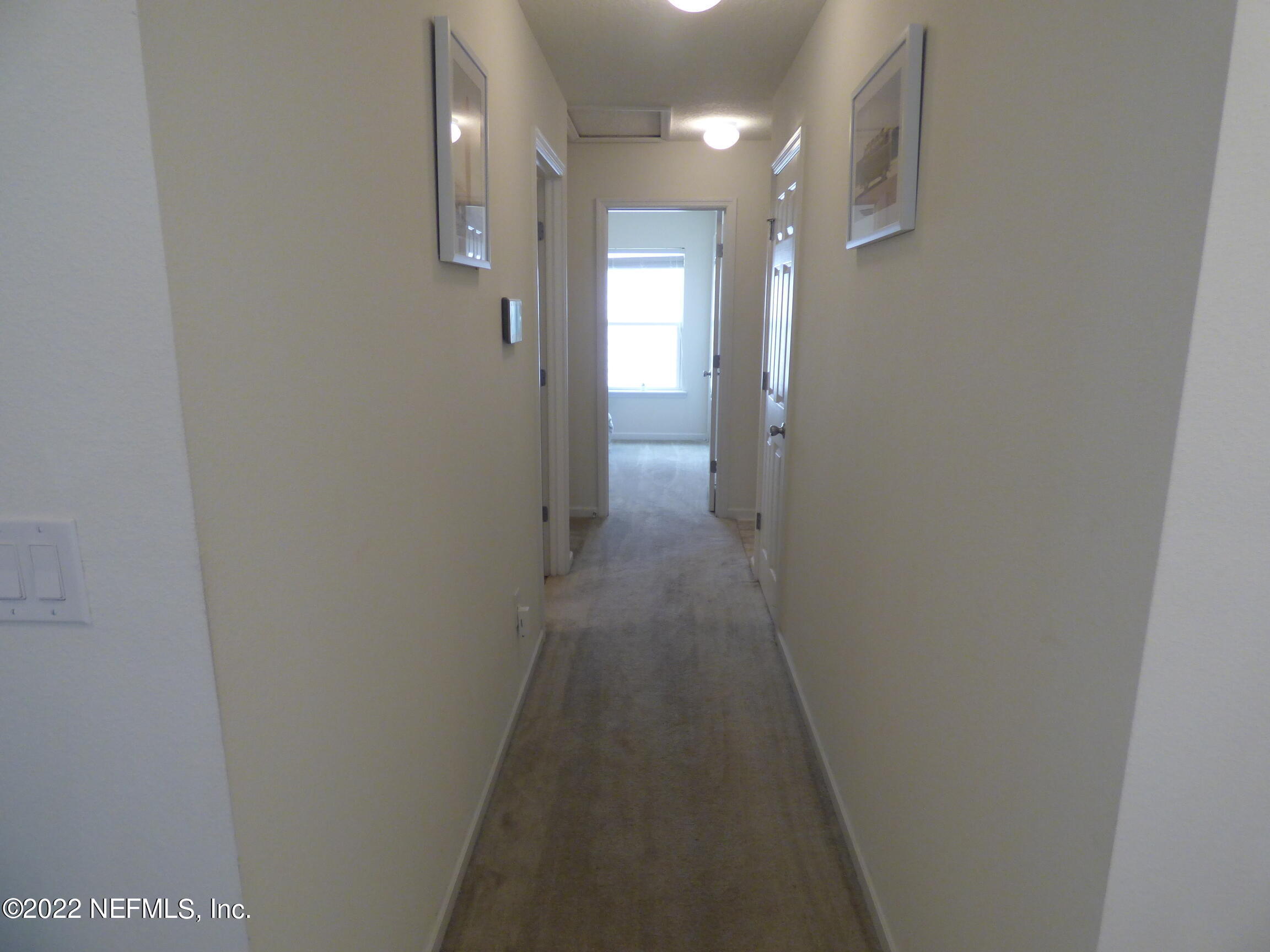 313 Bluejack Lane St. Augustine, FL 32095 - Photo 22 of 46 a view of a hallway with wooden floor
