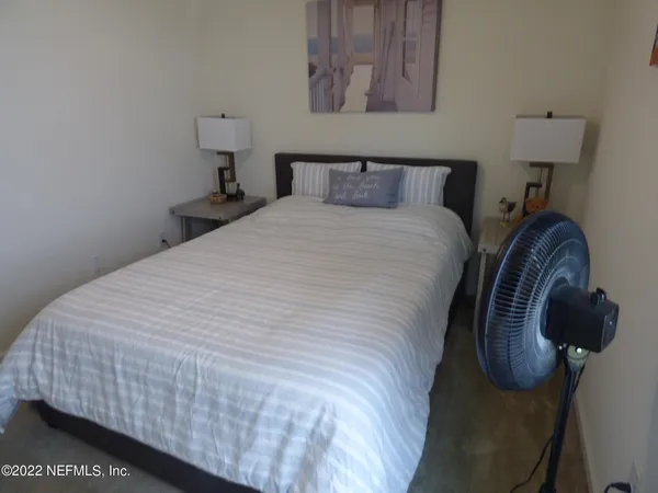 a bedroom with bed and wall painting