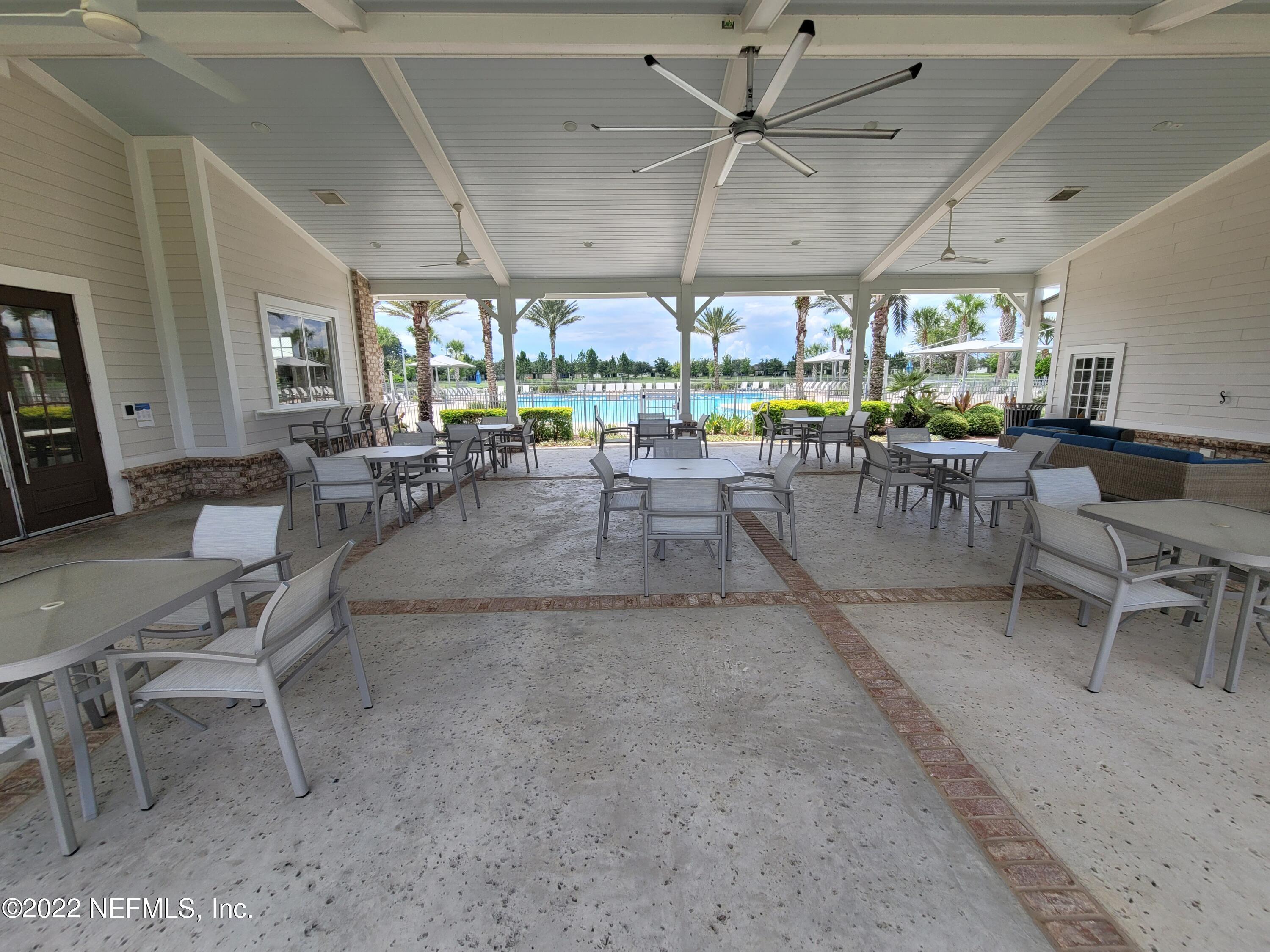 313 Bluejack Lane St. Augustine, FL 32095 - Photo 39 of 46 a view of a big room with lots of furniture and a large window