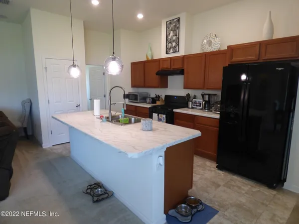 a kitchen with a sink cabinets and appliances