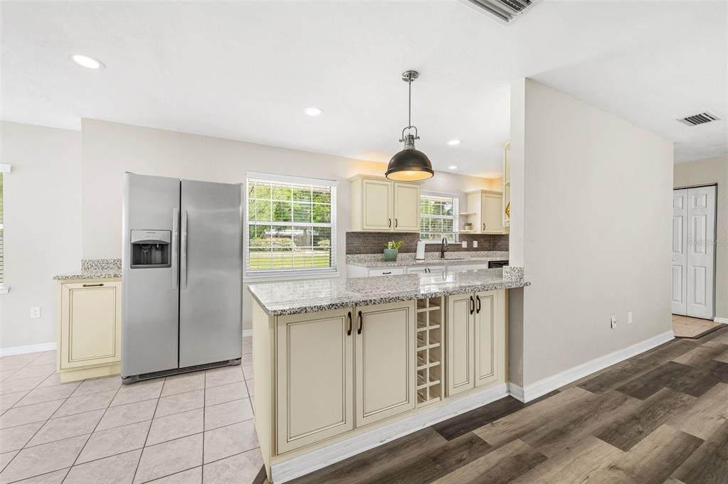 6820 Southwest 78th Street Gainesville, FL 32608 - Photo 12 of 41 a kitchen with stainless steel appliances granite countertop a sink a stove a refrigerator and cabinets