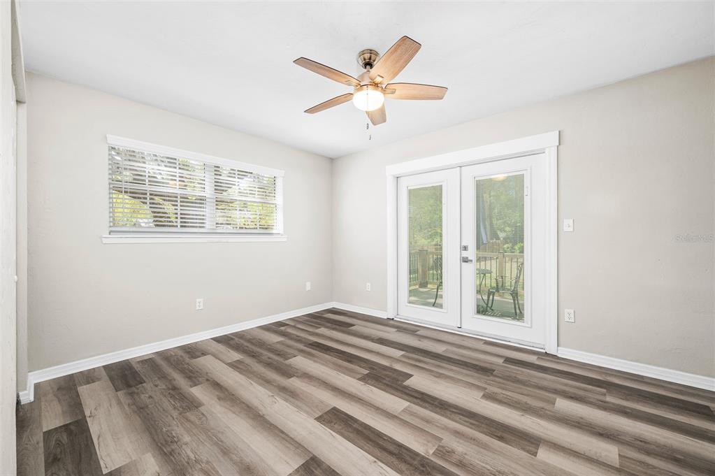 6820 Southwest 78th Street Gainesville, FL 32608 - Photo 15 of 41 a view of an empty room with wooden floor and a window