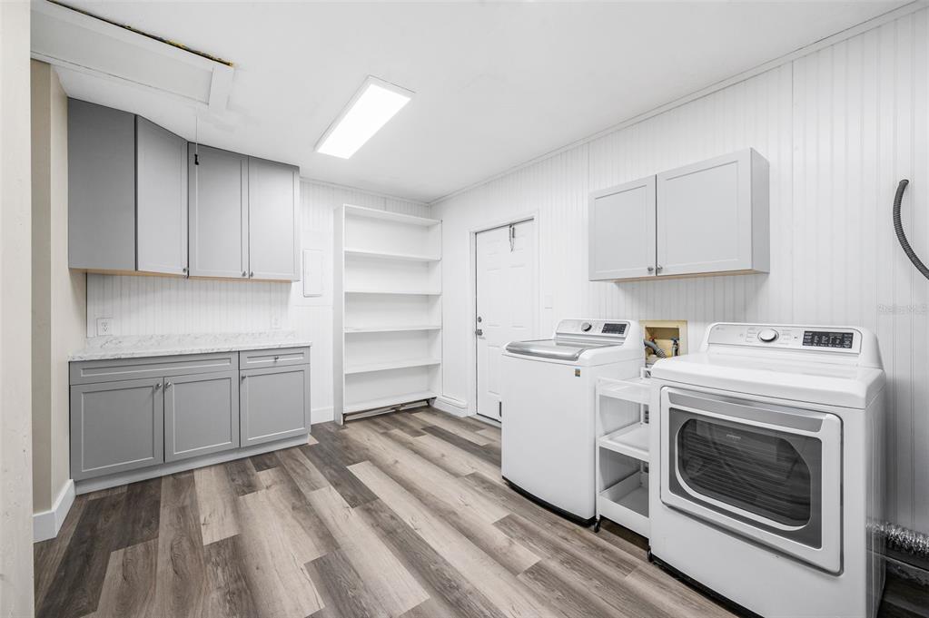 6820 Southwest 78th Street Gainesville, FL 32608 - Photo 23 of 41 a kitchen with a stove oven and white cabinets