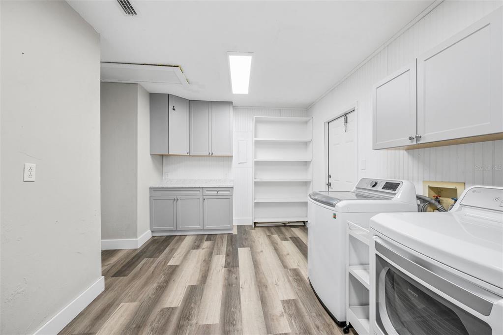 6820 Southwest 78th Street Gainesville, FL 32608 - Photo 25 of 41 a kitchen with a sink stove and cabinets