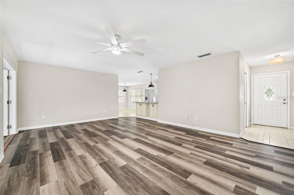 6820 Southwest 78th Street Gainesville, FL 32608 - Photo 5 of 41 a view of empty room with wooden floor and ceiling fan