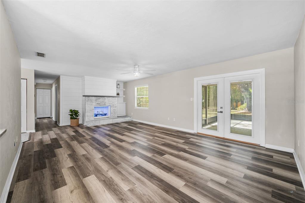 6820 Southwest 78th Street Gainesville, FL 32608 - Photo 7 of 41 a view of empty room with wooden floor and fireplace
