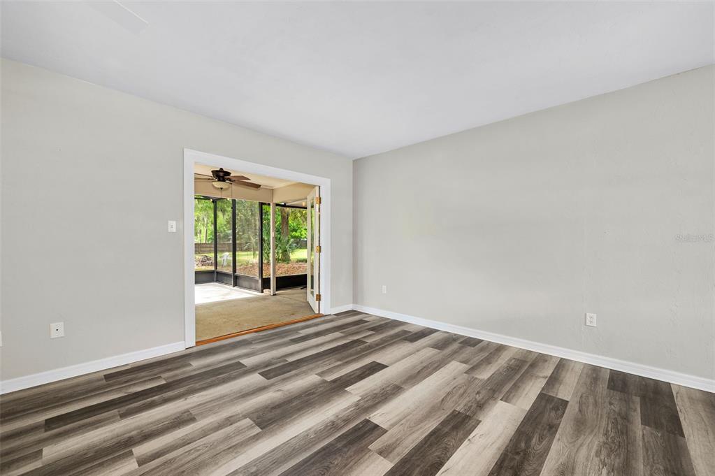 6820 Southwest 78th Street Gainesville, FL 32608 - Photo 8 of 41 a view of an empty room with wooden floor and a window