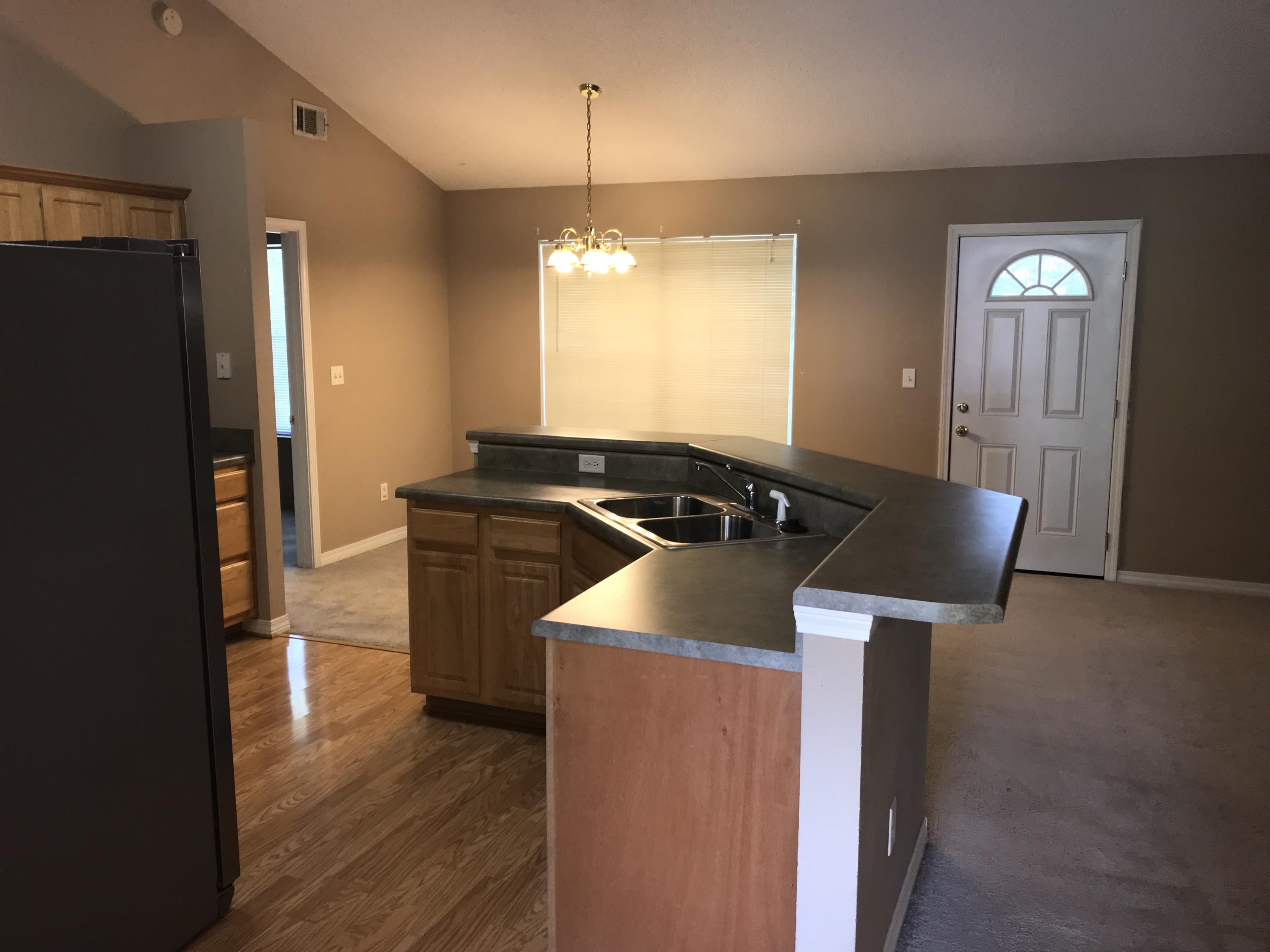 220 Tiffot Court Crestview, FL 32539 - Photo 2 of 15 a kitchen with granite countertop a stove and a refrigerator