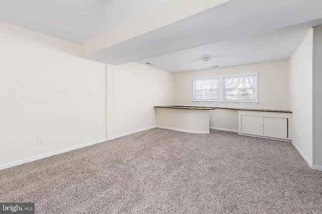an empty room with windows and closet