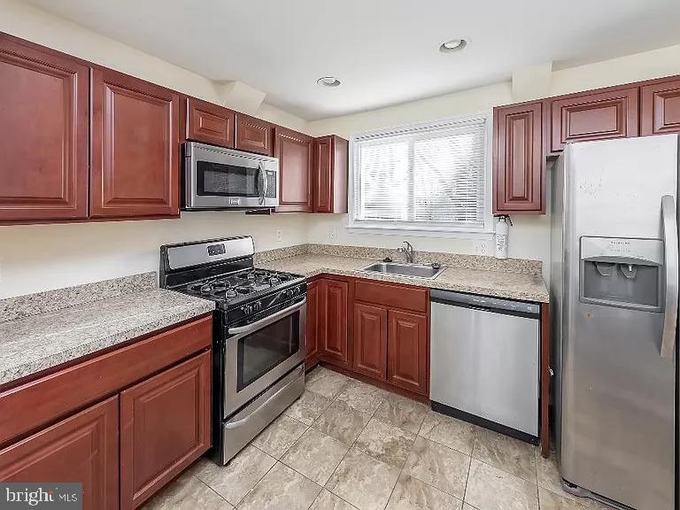 6 Cornell Road Glassboro, NJ 08028 - Photo 2 of 15 a kitchen with stainless steel appliances granite countertop a stove a sink dishwasher a refrigerator and a microwave