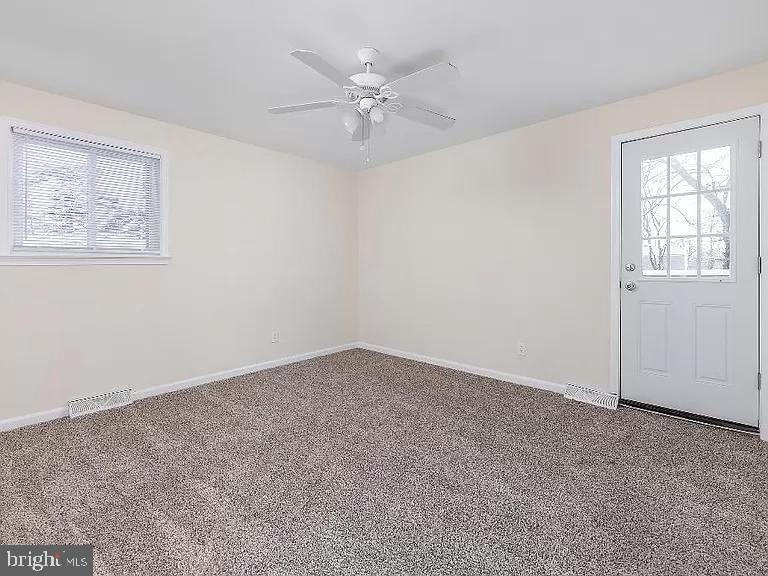 6 Cornell Road Glassboro, NJ 08028 - Photo 9 of 15 an empty room with a window and a ceiling fan