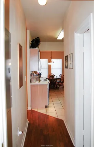 a kitchen with stainless steel appliances kitchen island granite countertop a stove a sink dishwasher and cabinets with wooden floor