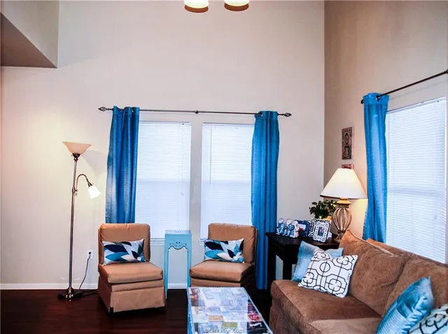 a living room with furniture and a lamp