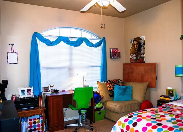 a bedroom with furniture and a window