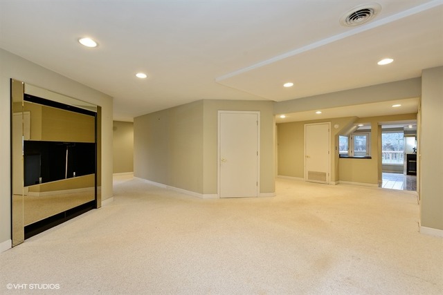 356 South Ela Road Inverness, IL 60010 - Photo 12 of 25 a view of an empty room with a fireplace and a cabinet