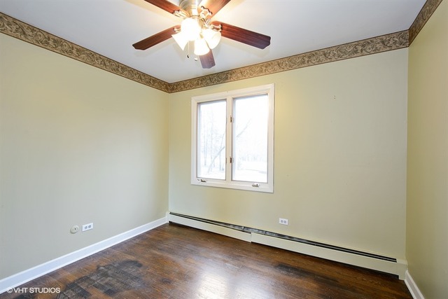 356 South Ela Road Inverness, IL 60010 - Photo 19 of 25 an empty room with wooden floor fan and windows