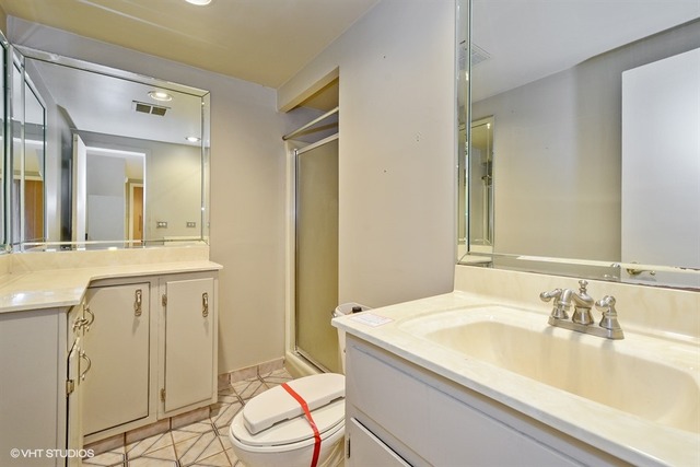 356 South Ela Road Inverness, IL 60010 - Photo 20 of 25 a bathroom with a granite countertop sink a toilet and a mirror
