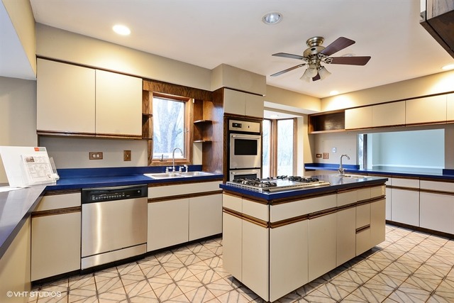356 South Ela Road Inverness, IL 60010 - Photo 5 of 25 a kitchen with stainless steel appliances a sink stove and cabinets